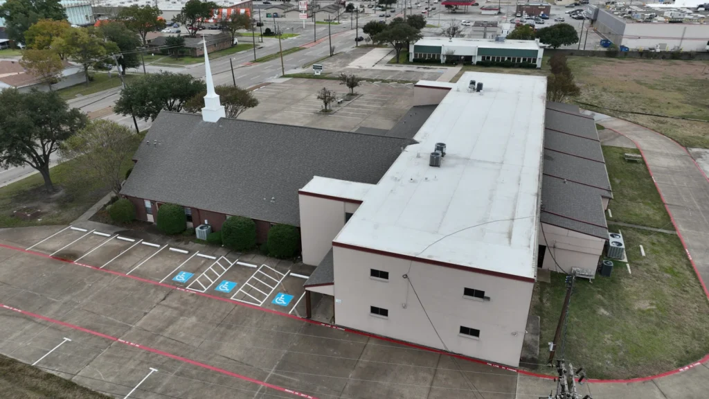 Aerial view of a commercial building roof and rooftop units