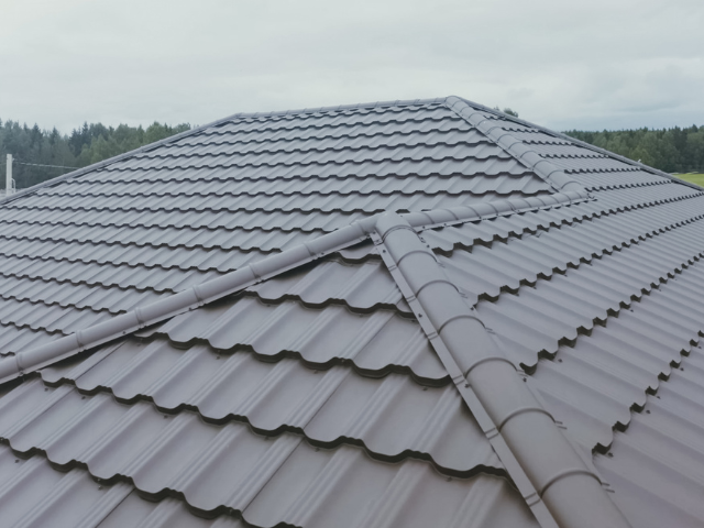 Wide view of a tile-profile roof showing ridge and valley detail