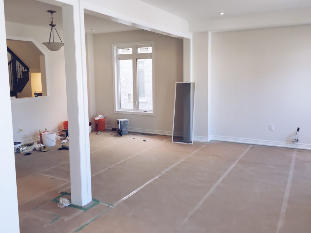 Living room with flooring covered and protected during a home renovation