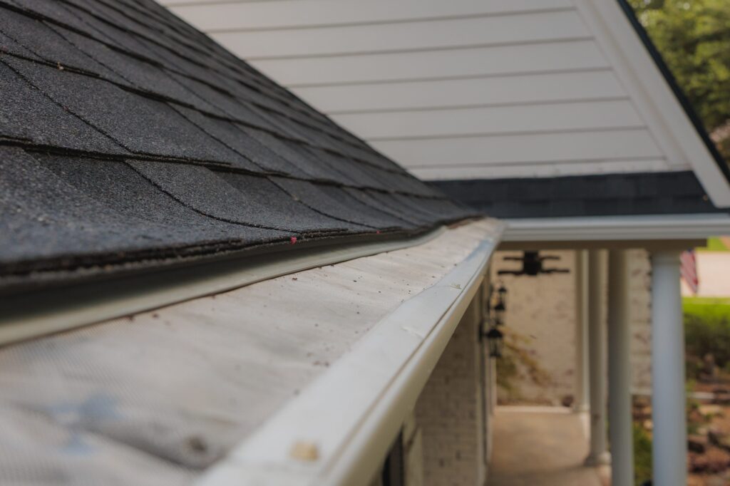 Gutter with leaf guard installed along the shingle edge of a North Texas home