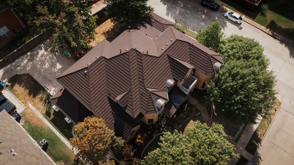 A drone capture of a finished stone-coated steel roof replacement in DeSoto, Texas (by Riddle Brothers Roofing & Construction)