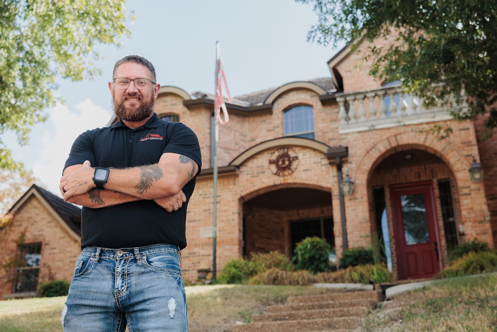 Max from Riddle Brothers in front of a finished roof replacement in DeSoto, Texas (by Riddle Brothers Roofing & Construction)