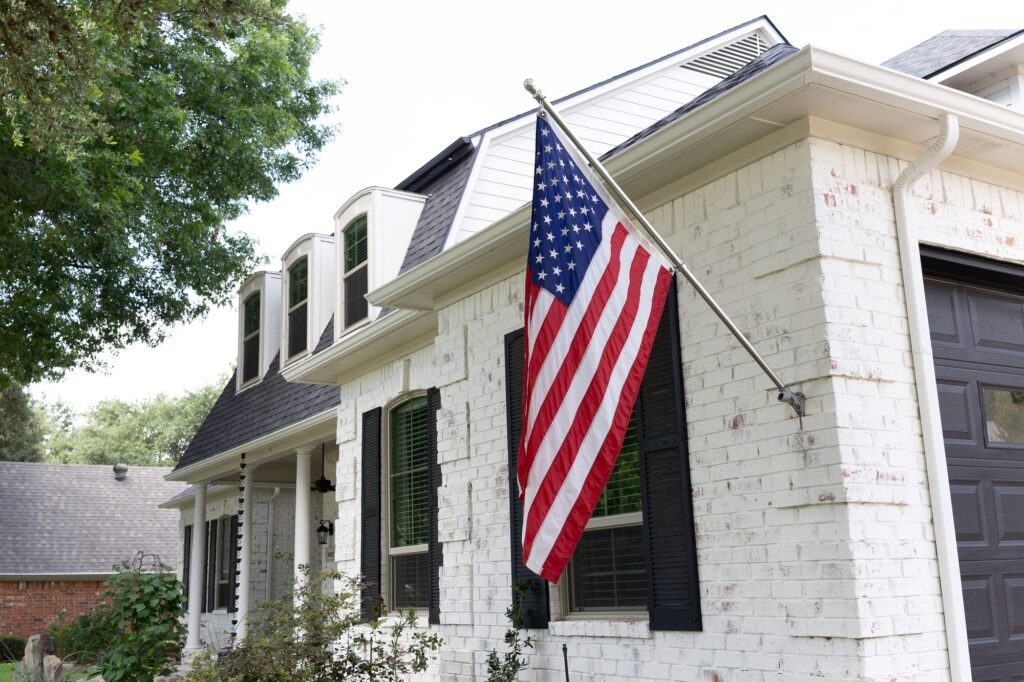 Downspout and gutter run on a white brick home