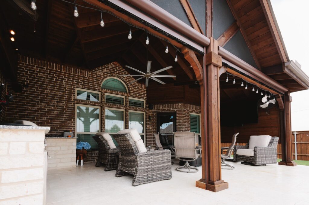 Covered patio with cedar ceiling and lounge seating built by Riddle Brothers